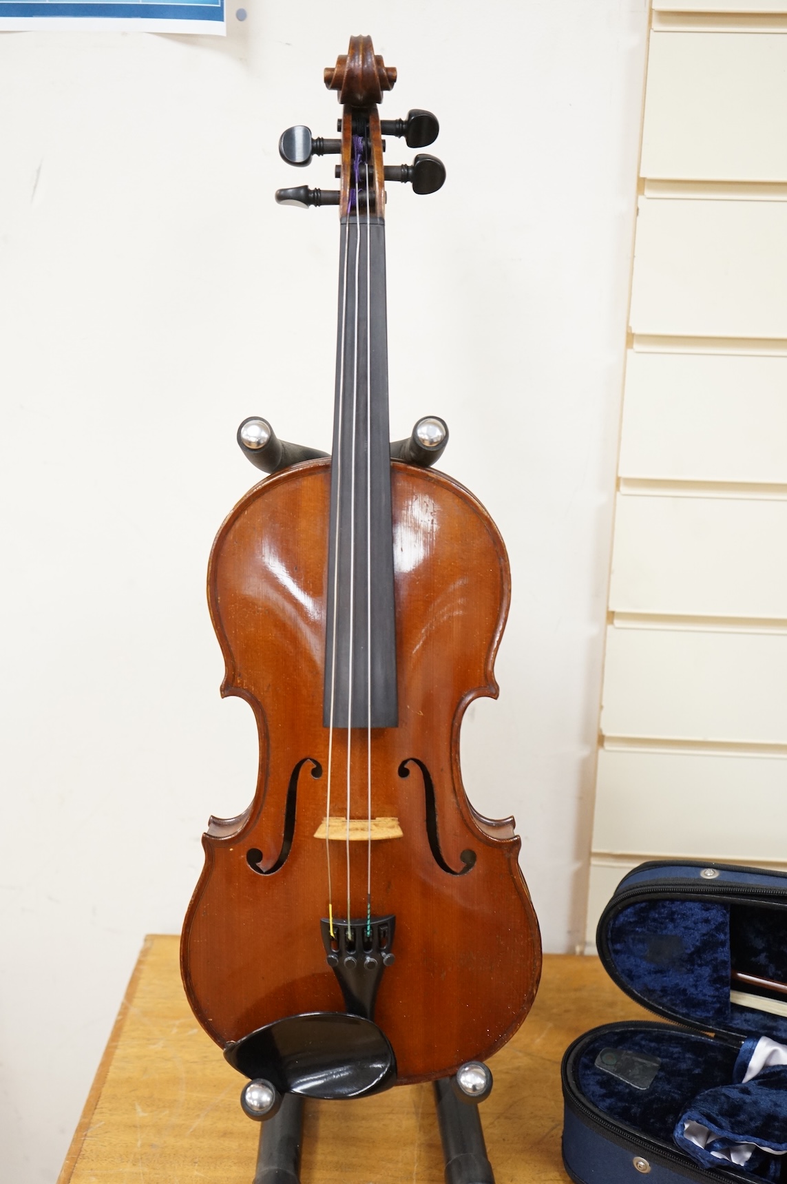 A cased late 19th century violin, signed ‘Nicolas Bertolini’, back 36.3cm, with bow stamped Paesold, CITES Submission reference, D9GSYMLJ
